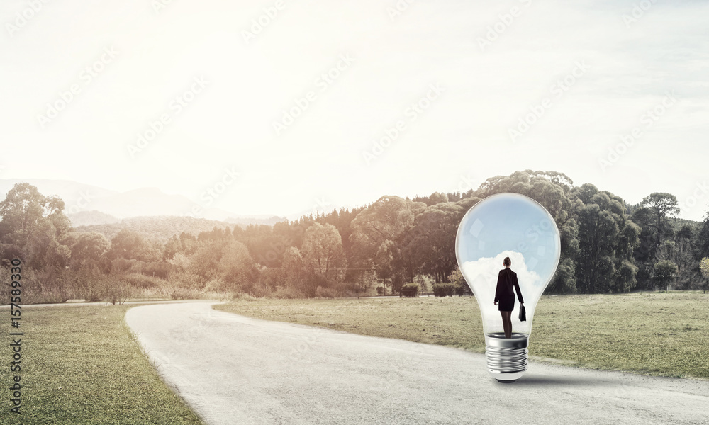 Businesswoman inside light bulb