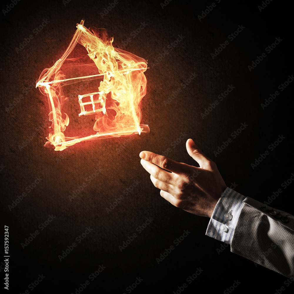 Businessman hand pointing at burning fire symbol