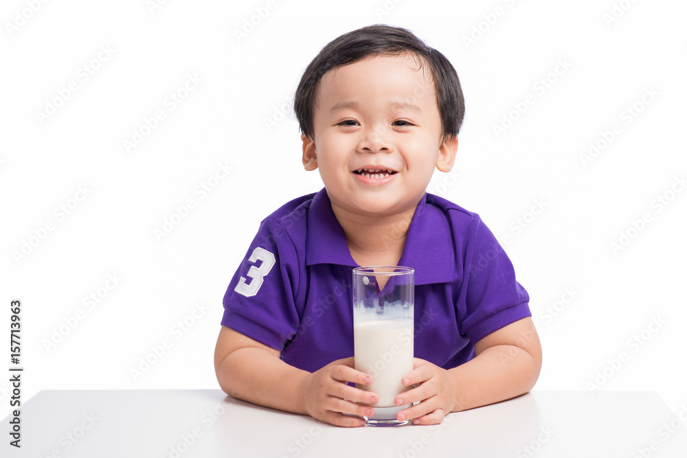 Little happy asian boy with glass of milk isolated on white background