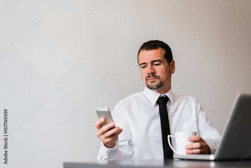 Attractive middle aged at work using phone