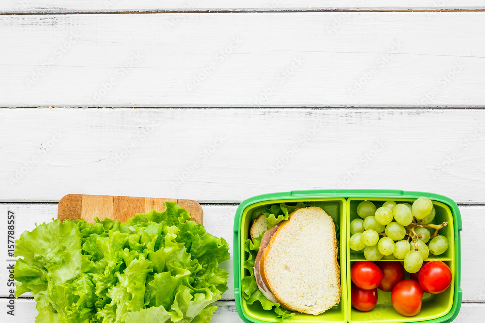 healthy food in lunchbox for dinner at school white table background top view mockup