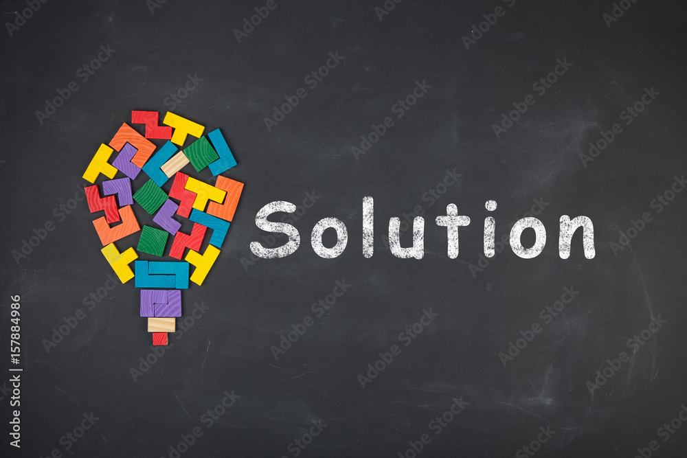 Business creative idea concept - inscription and jigsaw blocks on the blackboard