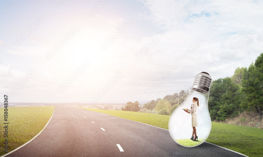 Businesswoman inside light bulb