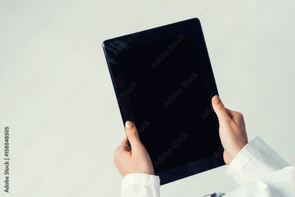 Close of female doctor hands working with tablet pc computer