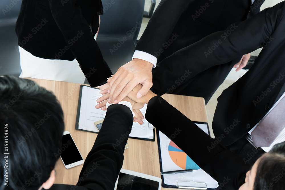 Close up of business partners making pile of hands at meeting. Business people collaboration teamwor