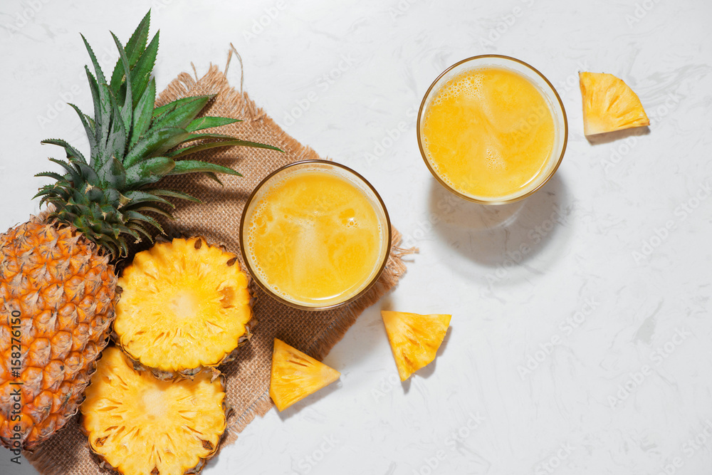 Top view of fresh pineapple juice in the glass with pineapple fruit