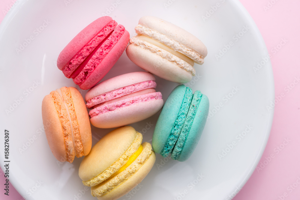 Colorful pastel cake macaron or macaroon on plate.