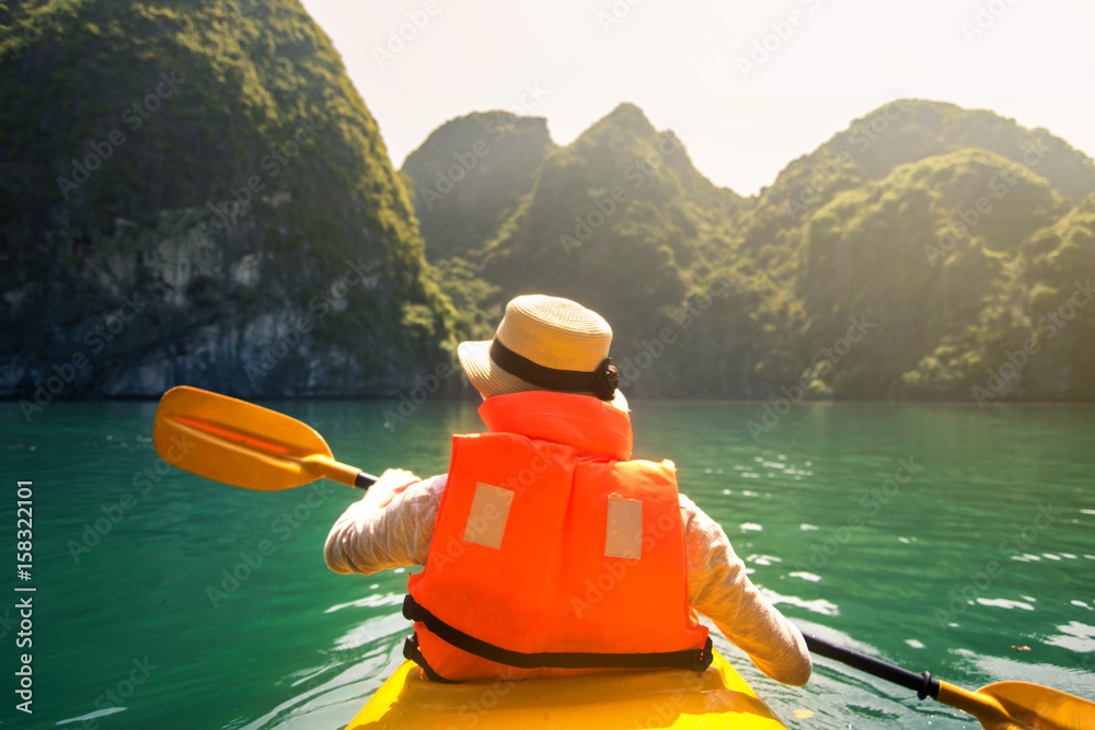 Tourist kayaking in Halong bay seaside of Vietnam