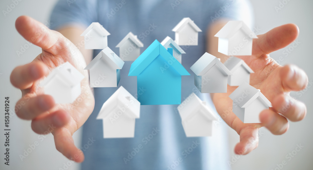 Businessman using 3D rendered small white and blue houses