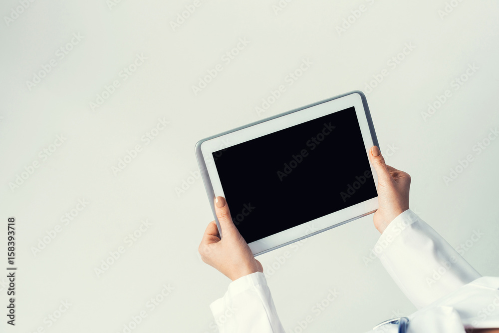 Close of female doctor hands working with tablet pc computer