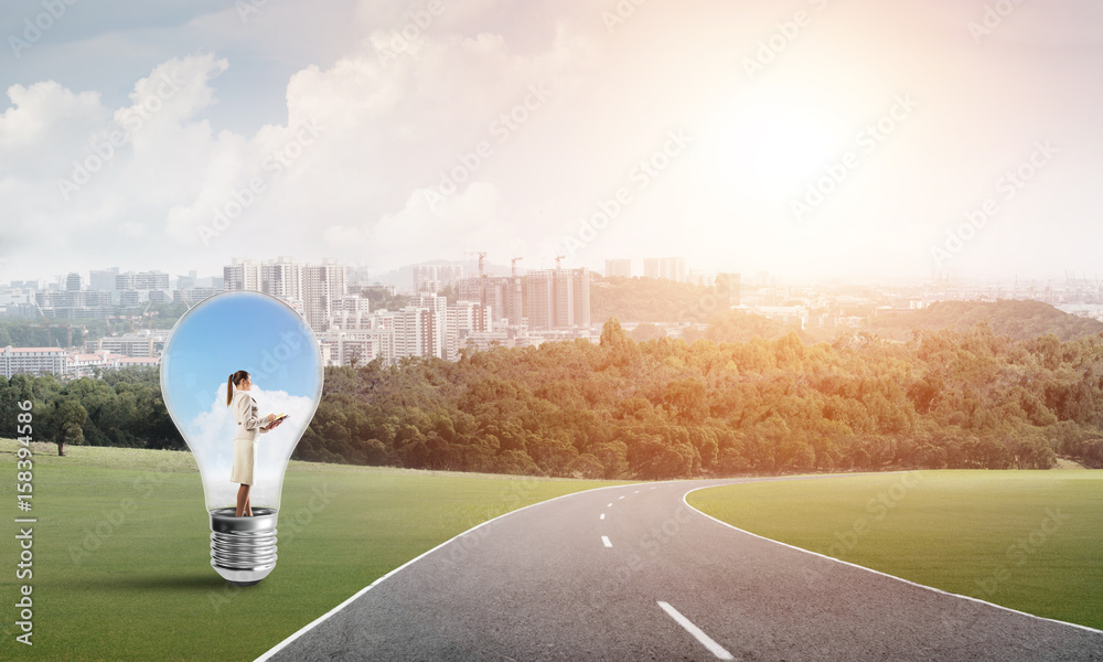 Businesswoman inside light bulb