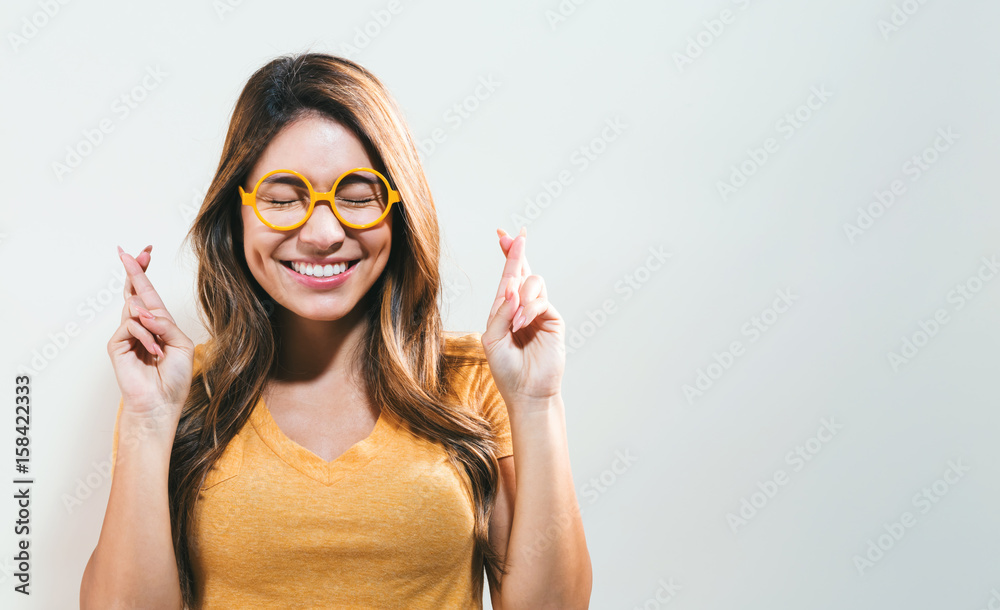 Young woman wishing for good luck