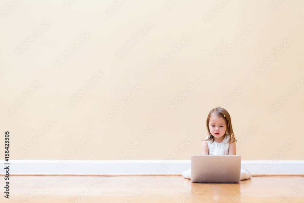 Little girl with her laptop computer