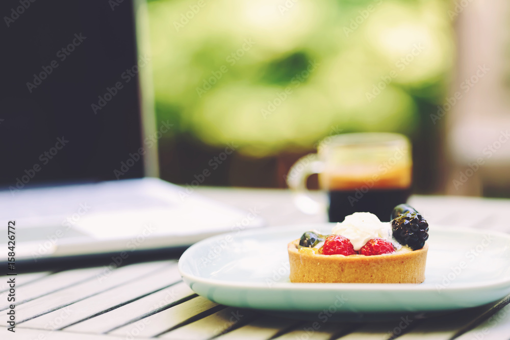 Desserts, coffee and laptop outside