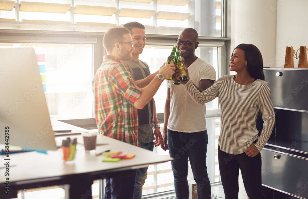 Cheerful young entrepreneurs relaxing with beer