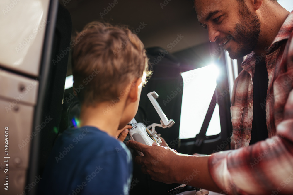 Father and son setting up a drone to fly