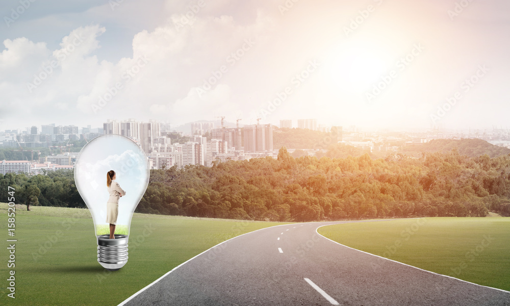 Businesswoman inside light bulb