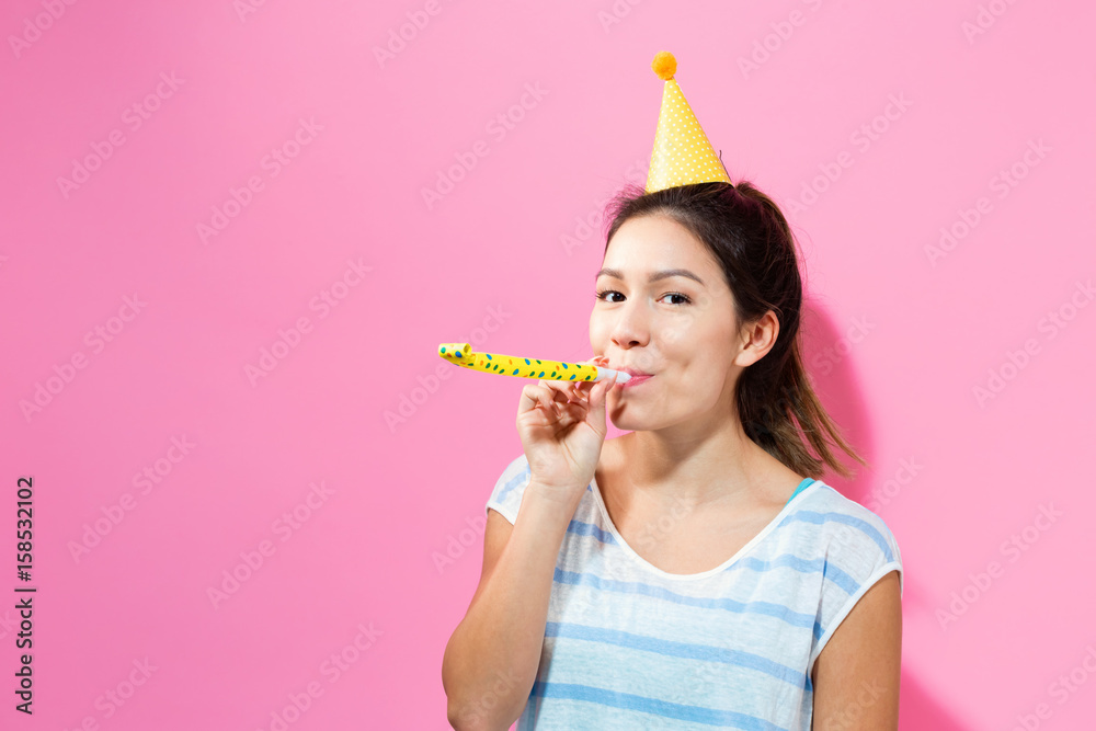 Young woman with noisemaker