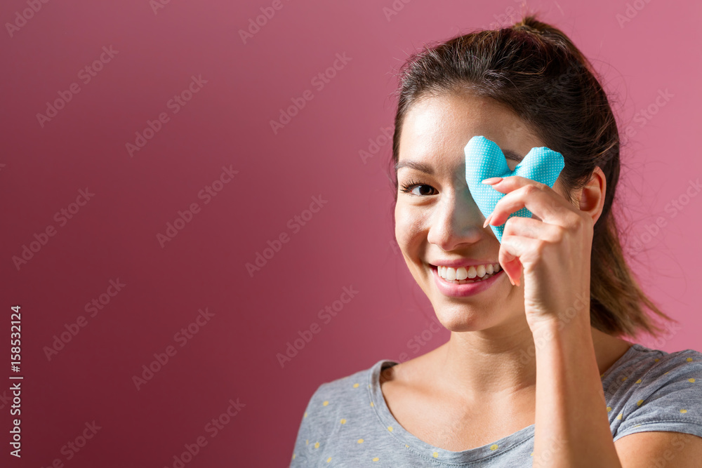 Happy young woman holding a heart