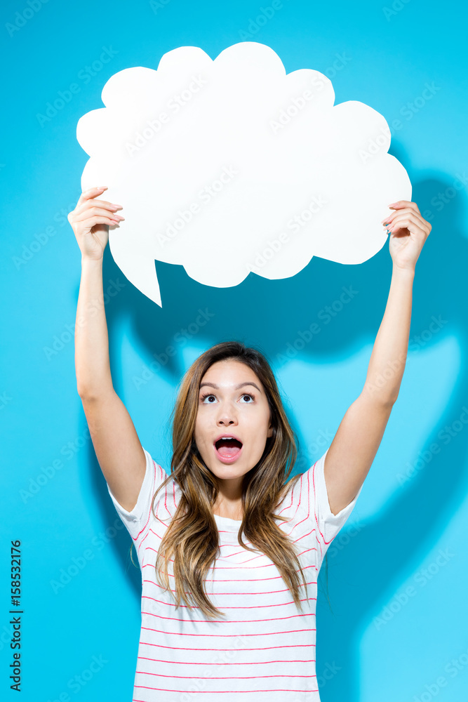 Young woman holding a speech bubble