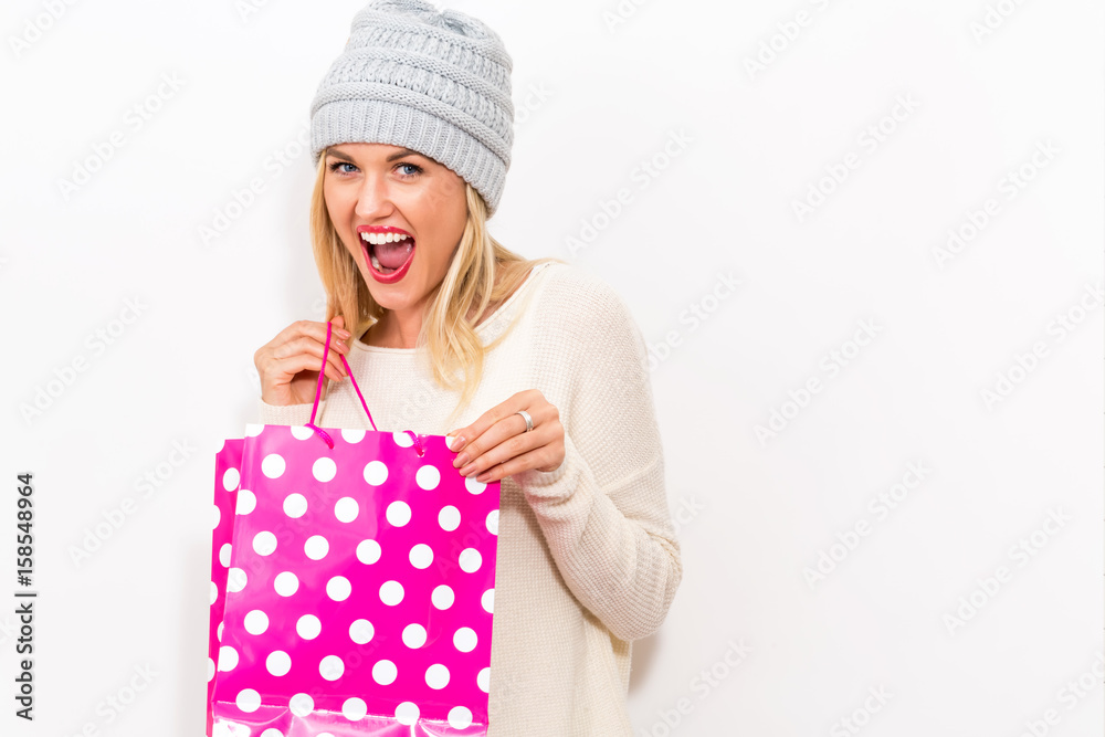 Happy young woman holding a shopping bag