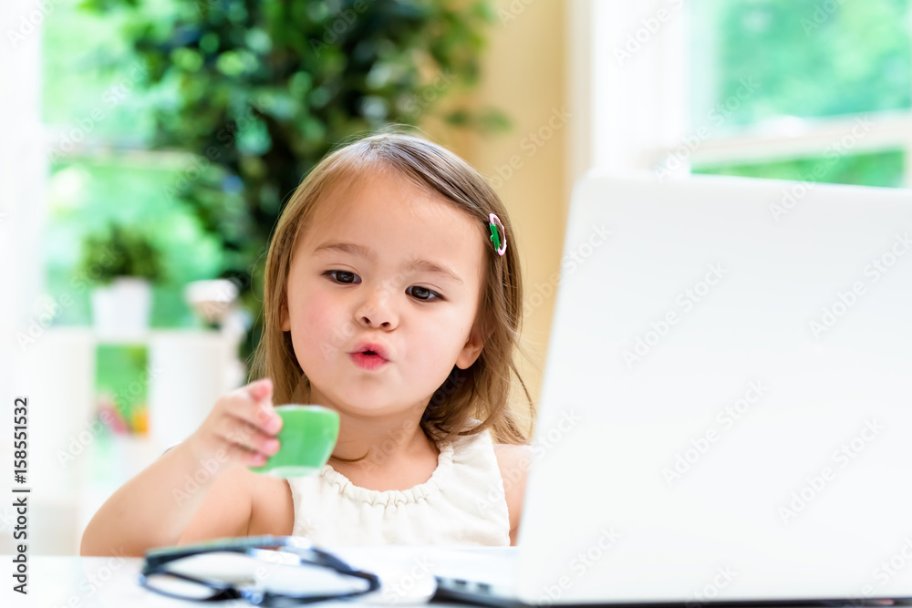 Little girl with her laptop computer