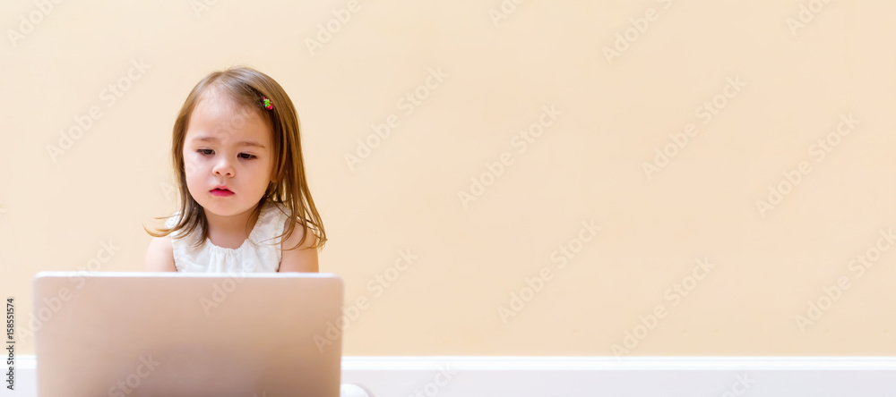 Little girl with her laptop computer