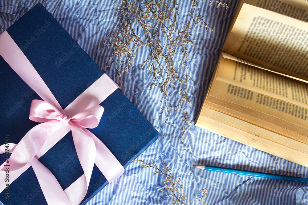 Dark blue gift box with  ribbon decoration with book and flower on polka blue paper , Happy Fathers