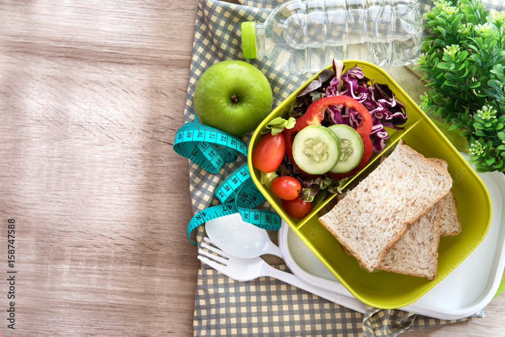 Healthy Lunch box with grain bread and fresh water drink  bottle on wooden background  ,Healthy eati