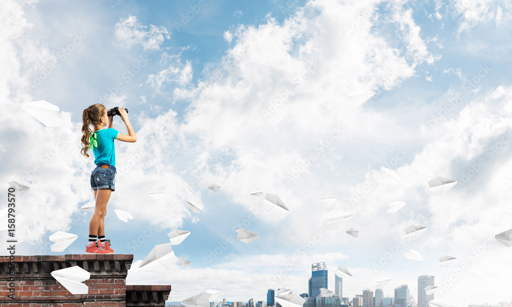 Concept of careless happy childhood with girl of school age looking in future