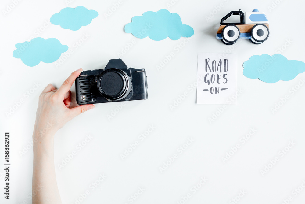 accessories for treveling with children, camera and toys on white background top view mock-up