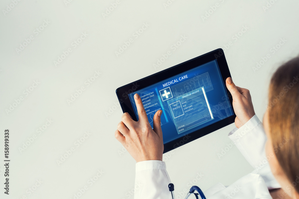 Close of female doctor hands working with tablet pc computer