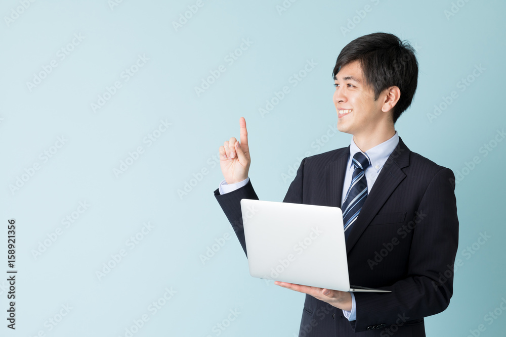 portrait of asian businessman isolated on blue background