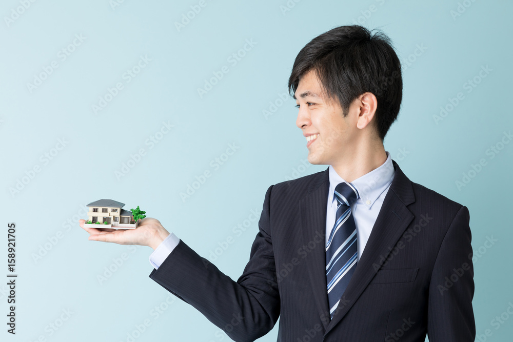 portrait of asian businessman isolated on blue background