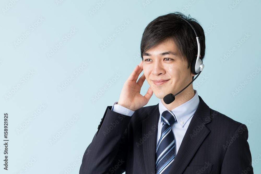 portrait of asian businessman isolated on blue background