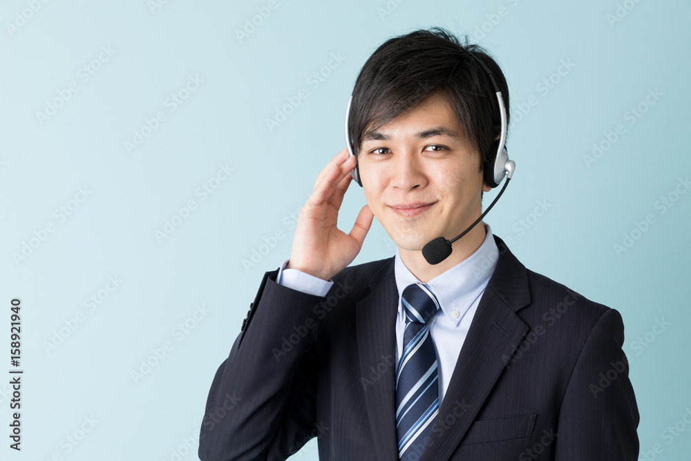 portrait of asian businessman isolated on blue background