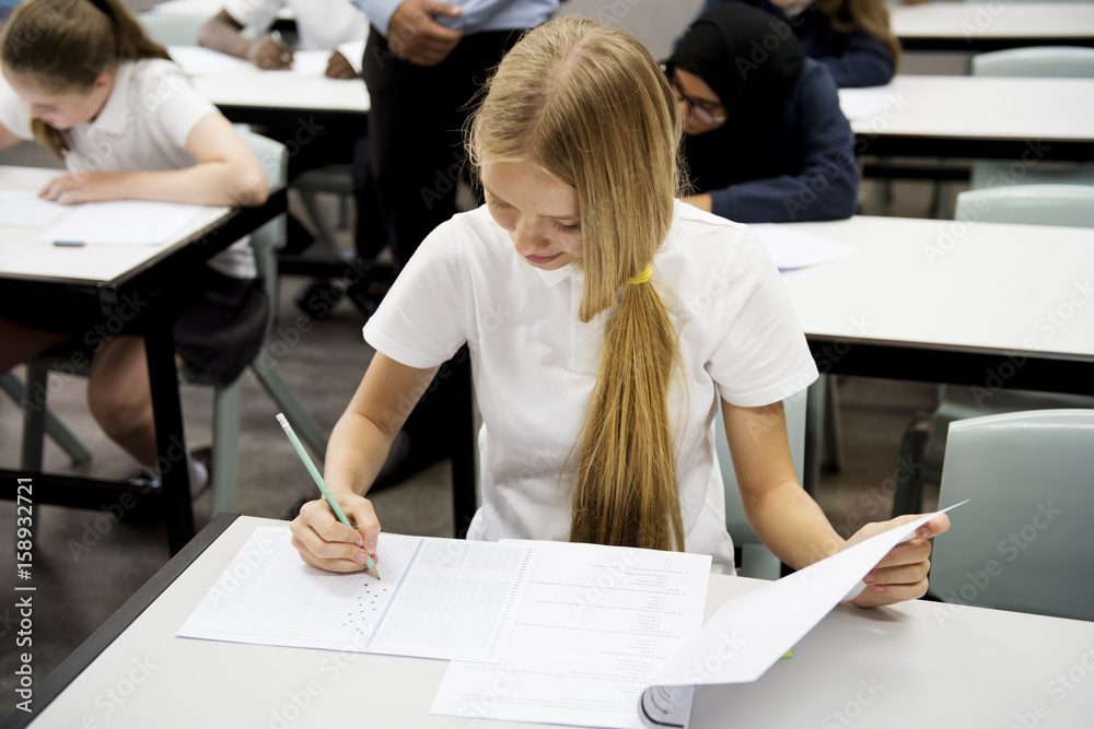 Students doing the exam in classroom