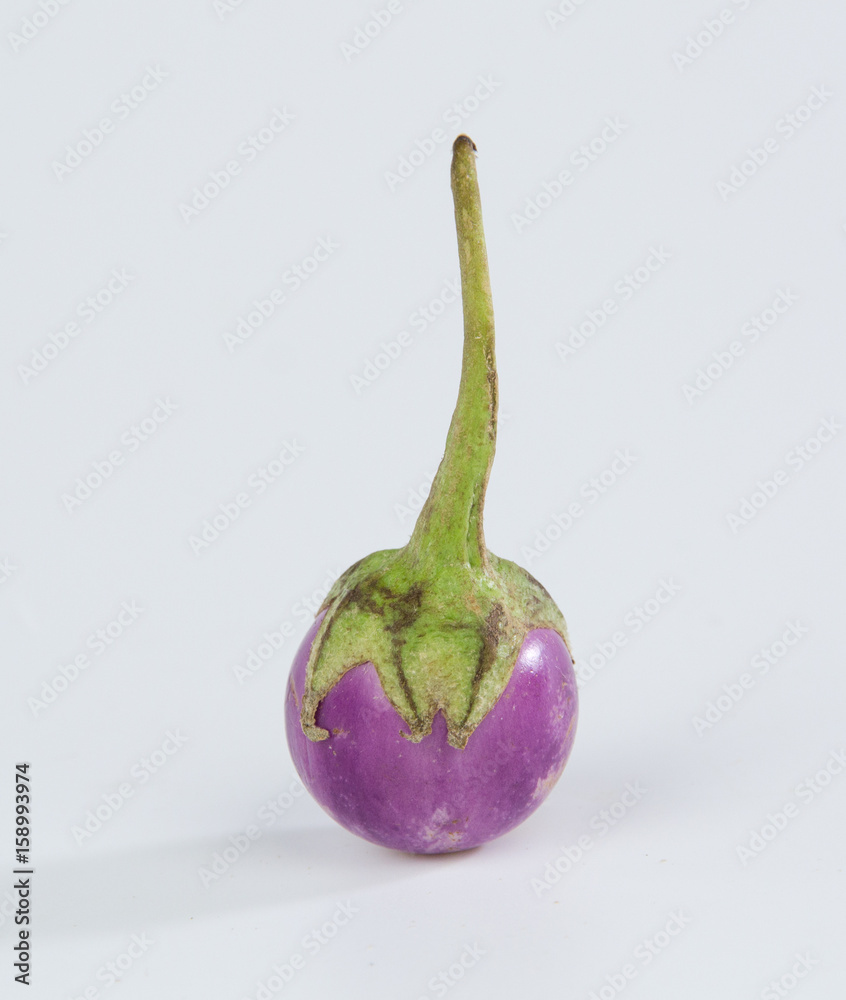 Pearl eggplant in a bamboo basket isolated on white background
