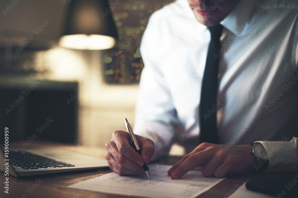 Cropped view of serious businessman signing contract