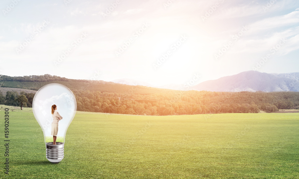 Businesswoman inside light bulb