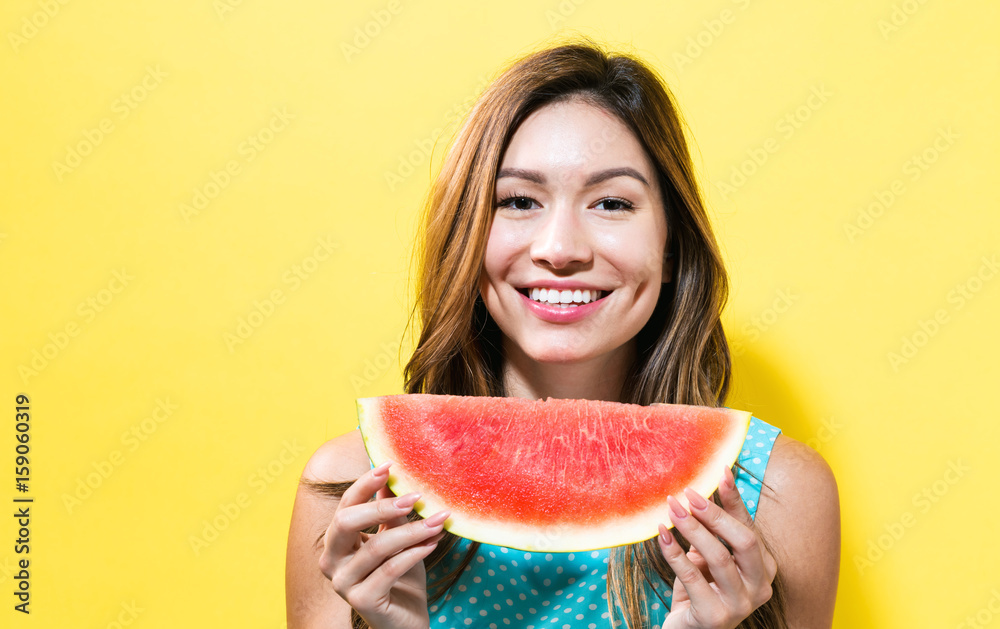  Happy young woman holding watermelon