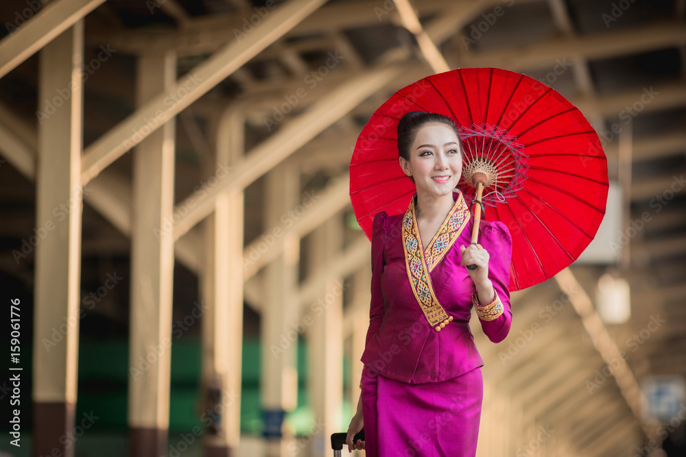 Beautiful Thai girl in Thai costume,Asian woman wearing traditional Thai culture at train station,Ba