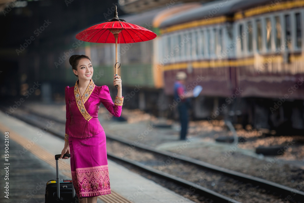 Beautiful Thai girl in Thai costume,Asian woman wearing traditional Thai culture at train station,Ba