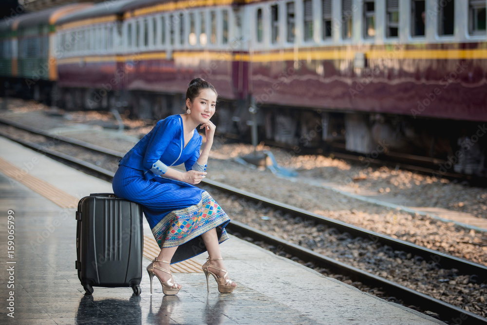 Beautiful Thai girl in Thai costume,Asian woman wearing traditional Thai culture at train station,Ba