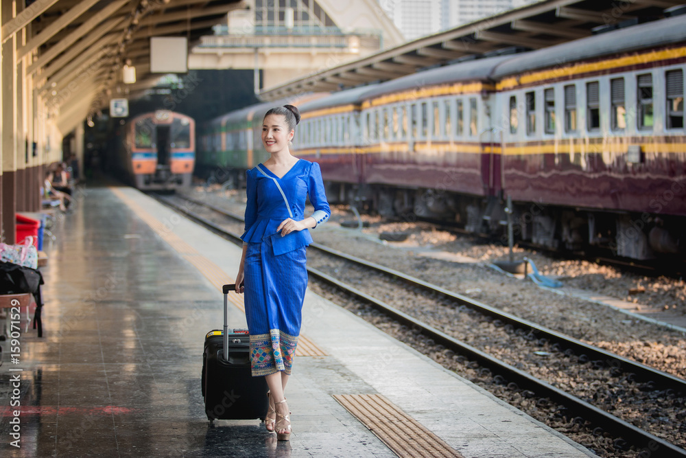 Beautiful Thai girl in Thai costume,Asian woman wearing traditional Thai culture at train station,Ba