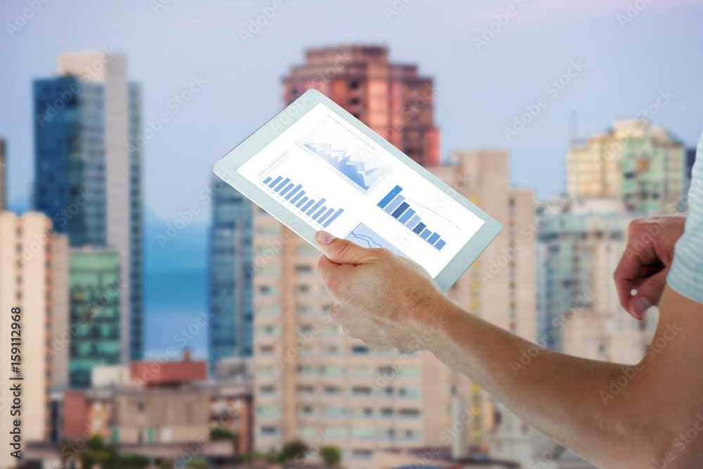 Composite image of man holding digital tablet