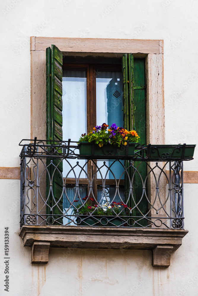 Fenster mit schmiedeeisernem Balkon un dBlumen