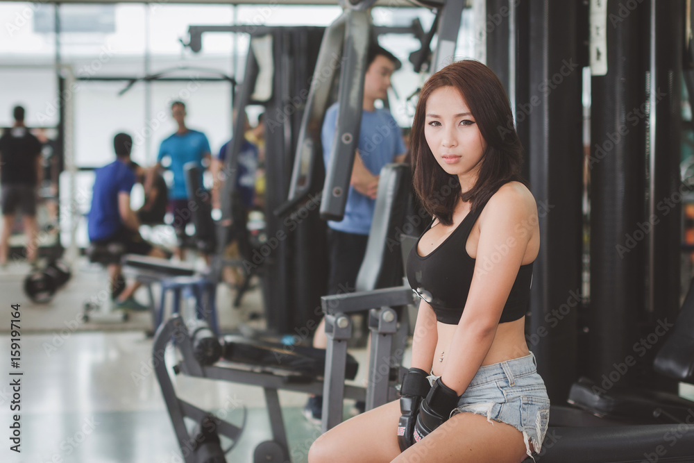 Sports women exercises at the gym.