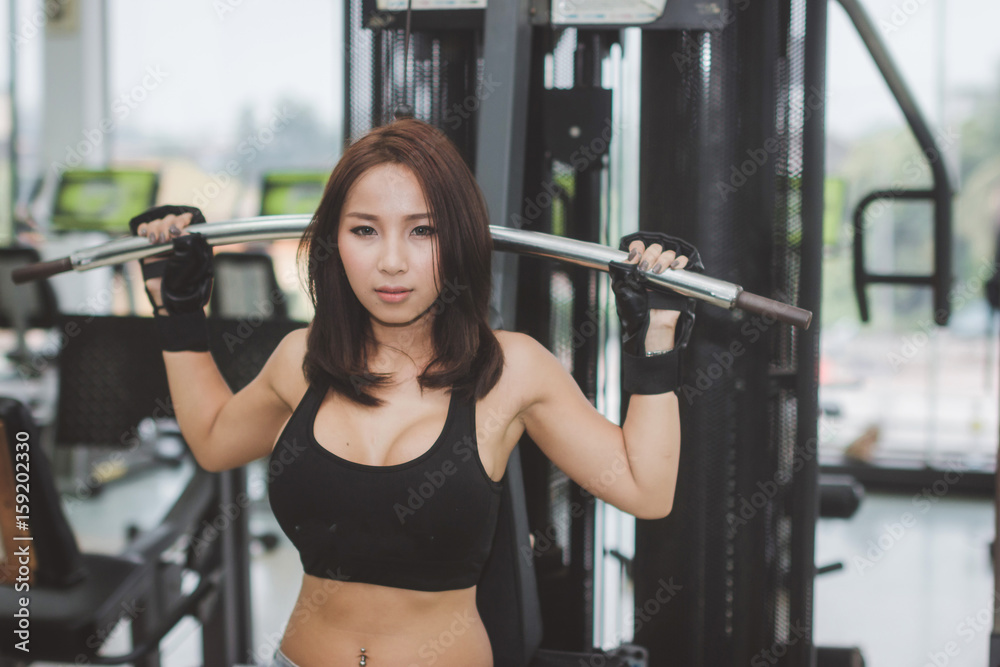 Sports women exercises at the gym.