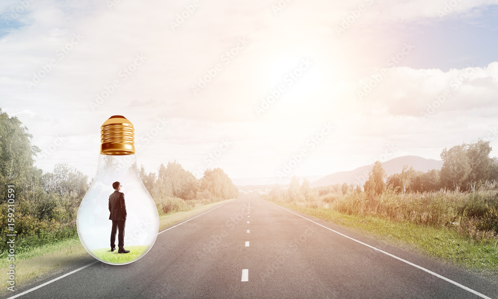 Businessman inside light bulb